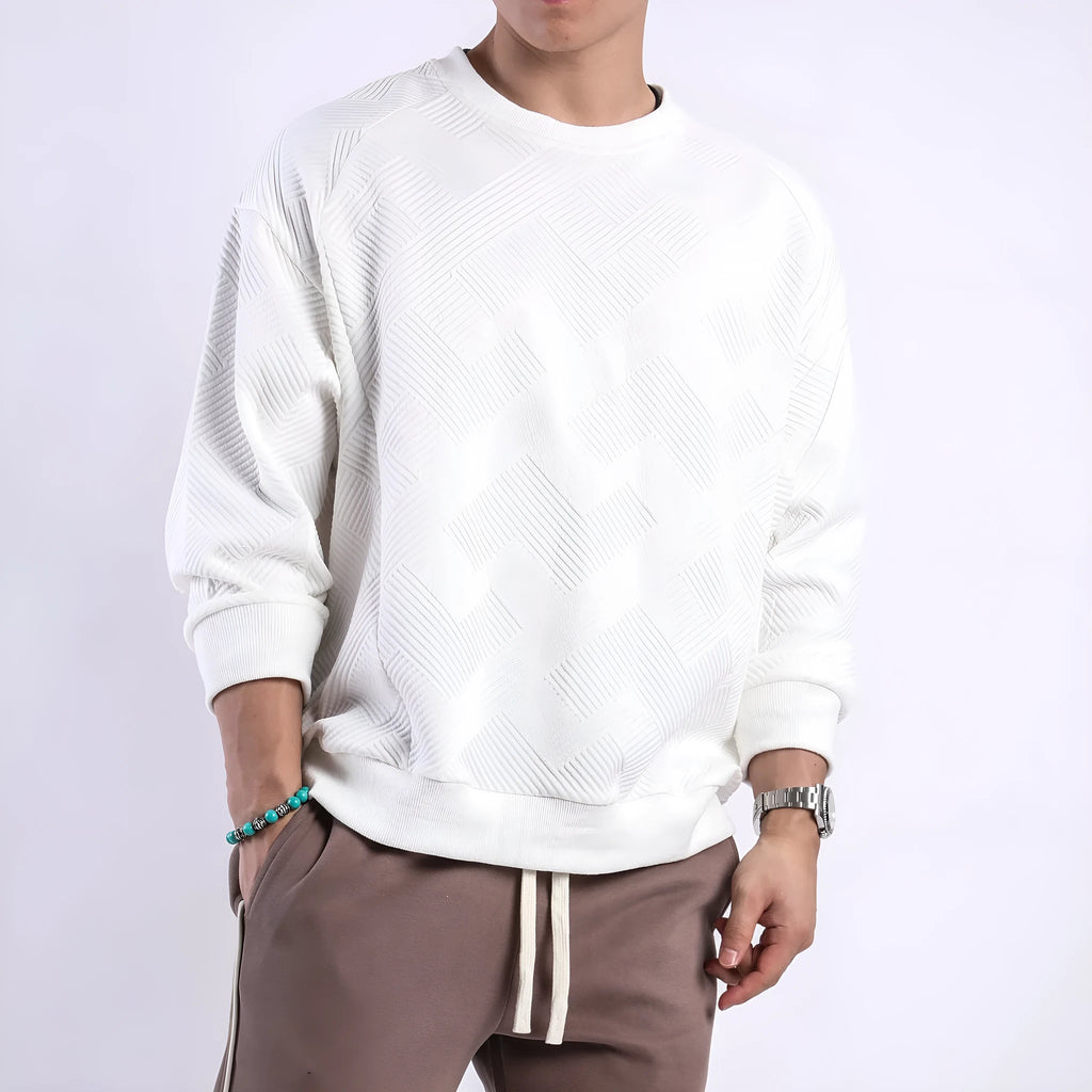 Man wearing a loose-fit army green twill jacquard long-sleeved pullover sweater.