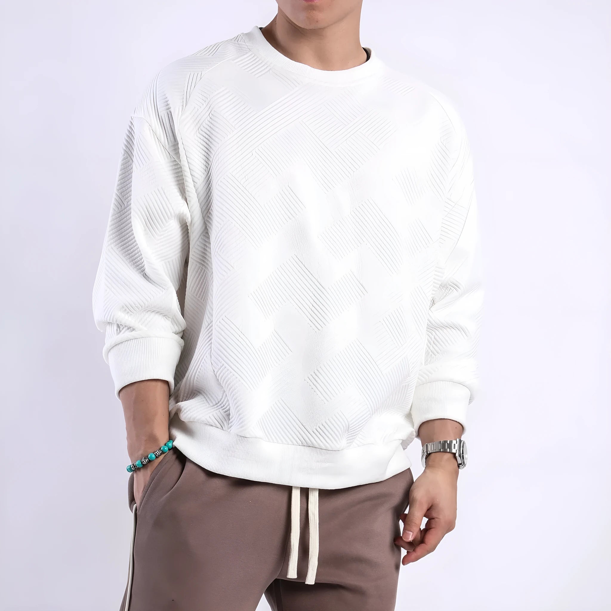 Man wearing a loose-fit army green twill jacquard long-sleeved pullover sweater.