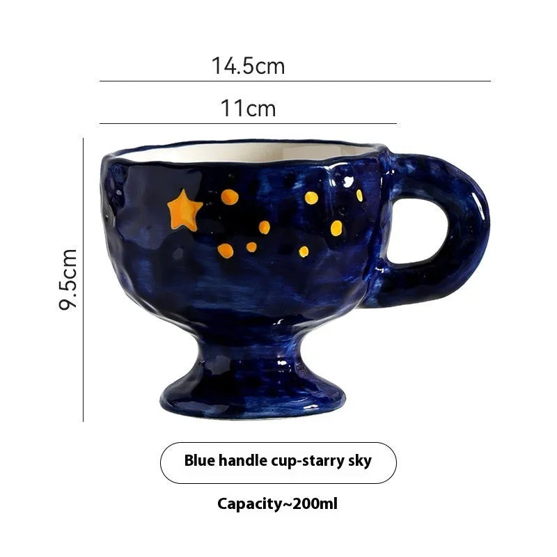 Hand-pinched irregularly shaped ceramic mug in a solid colour, shown on a table.