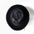 Handmade wool felt conical hat with skull design showing conical silhouette and wool texture