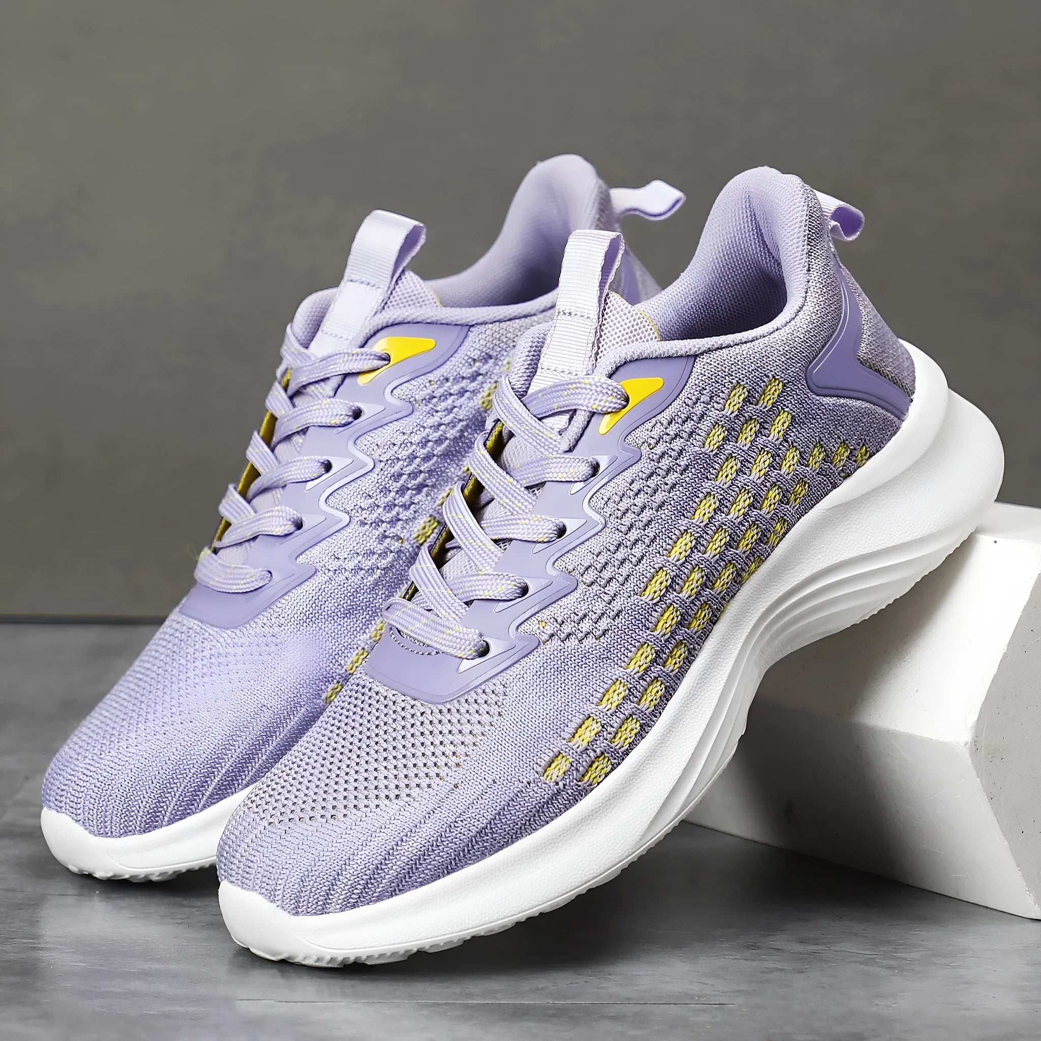 Lavender purple women's Flyknit running shoes with striped pattern, mesh lining, and a flat EVA wedge sole.