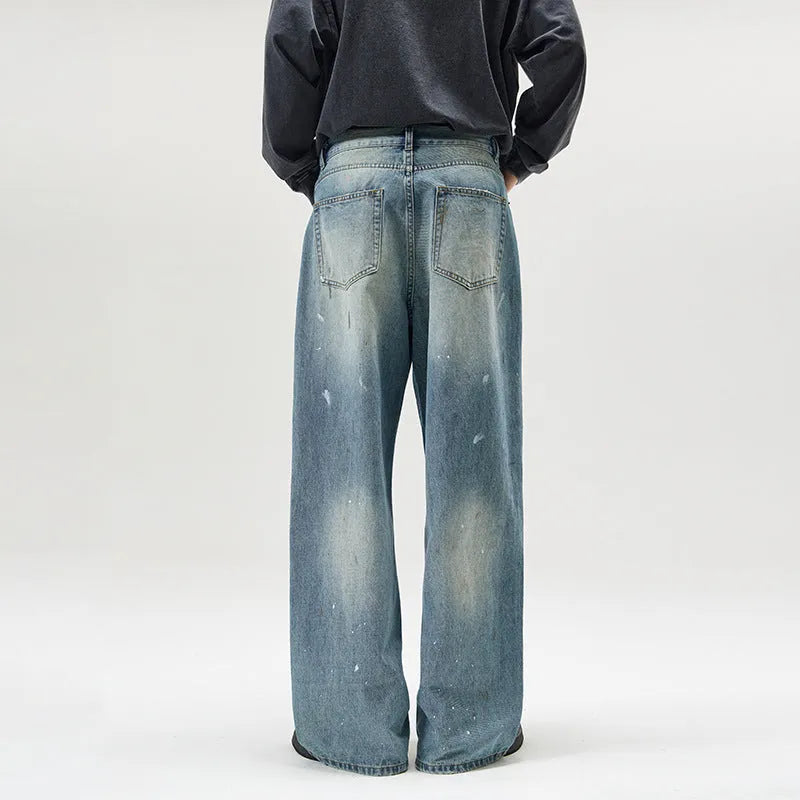 Men's loose fit splash-ink washed denim jeans in Ice Blue on a model, front view