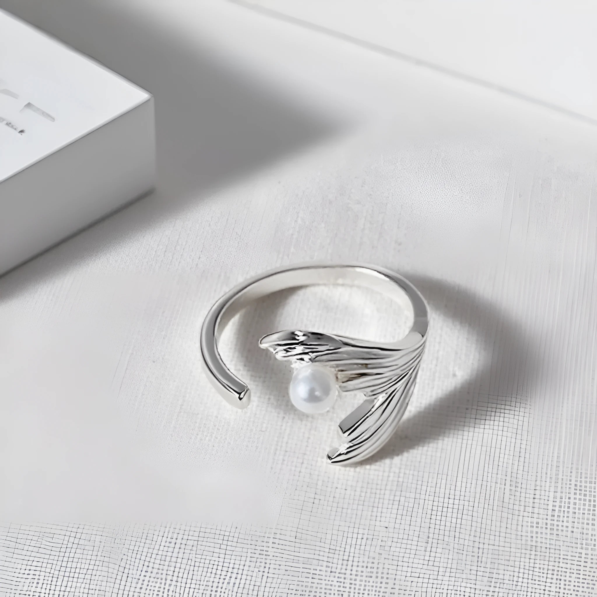 Fishtail pearl little finger ring made of electroplated alloy in free size for unisex wear.