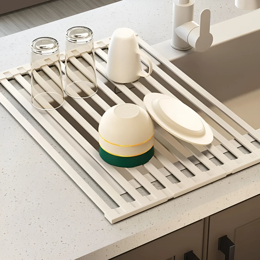 Milky white foldable stainless steel kitchen draining rack shown over a sink.