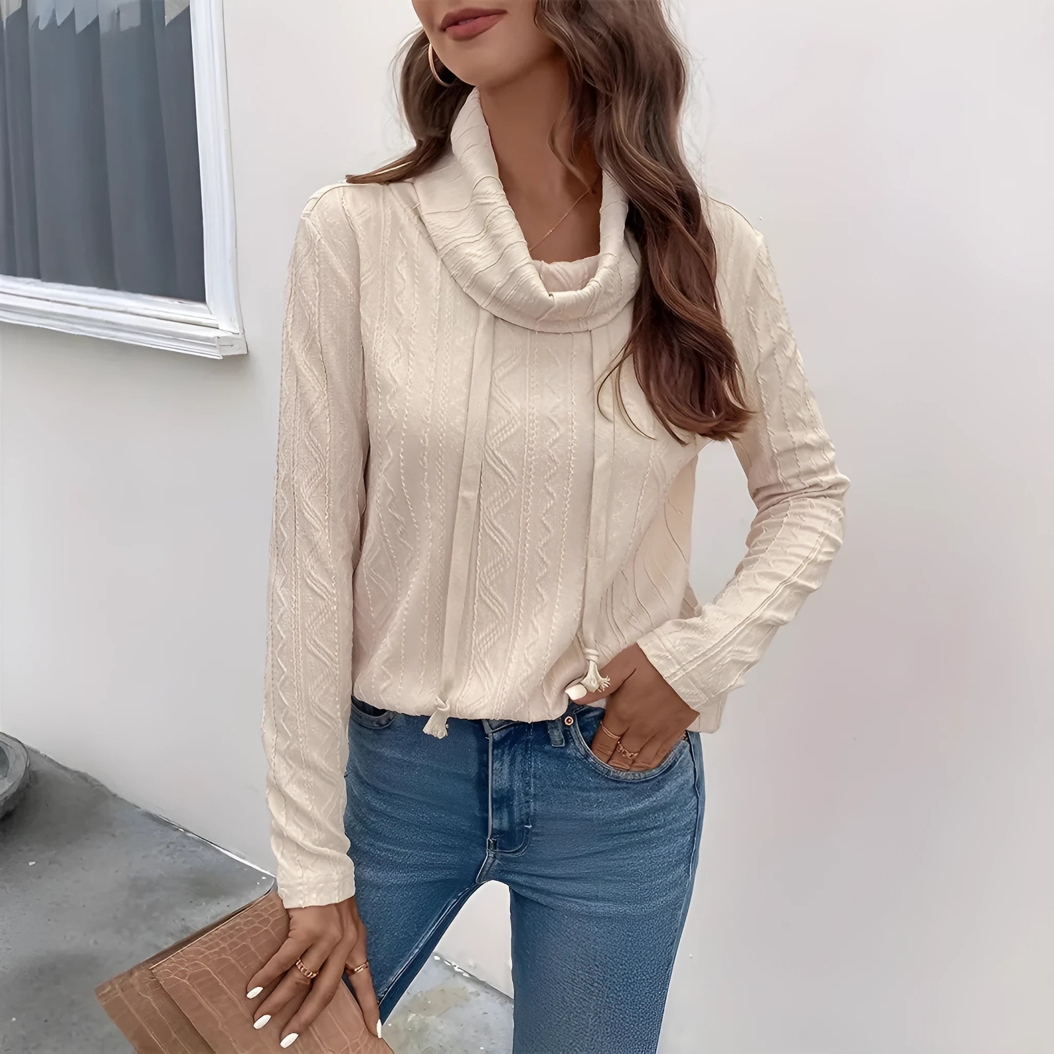 Apricot coloured long sleeve hooded pullover sweater on a hanger