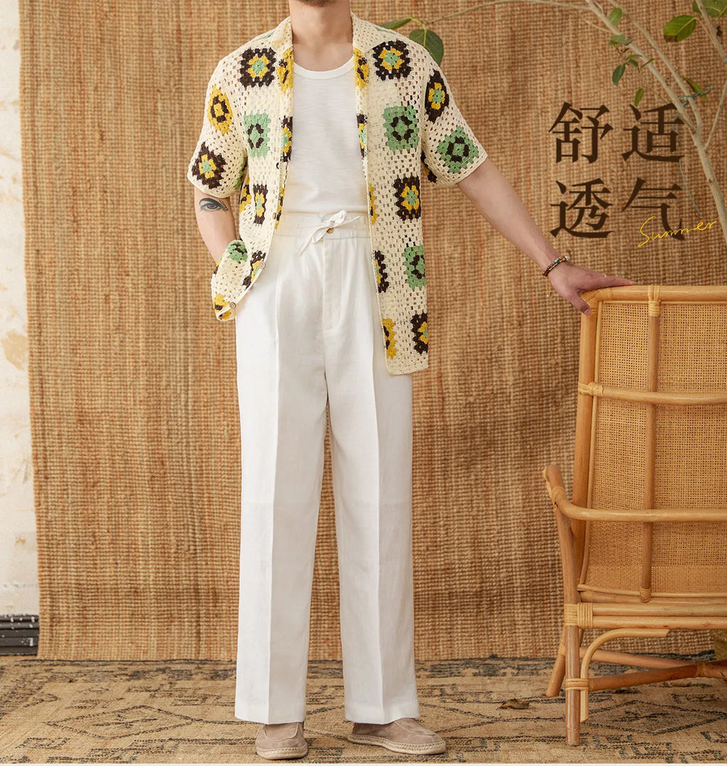 A pair of loose-fit, high-waisted linen trousers in a neutral colour with an elasticated waistband and straight legs.