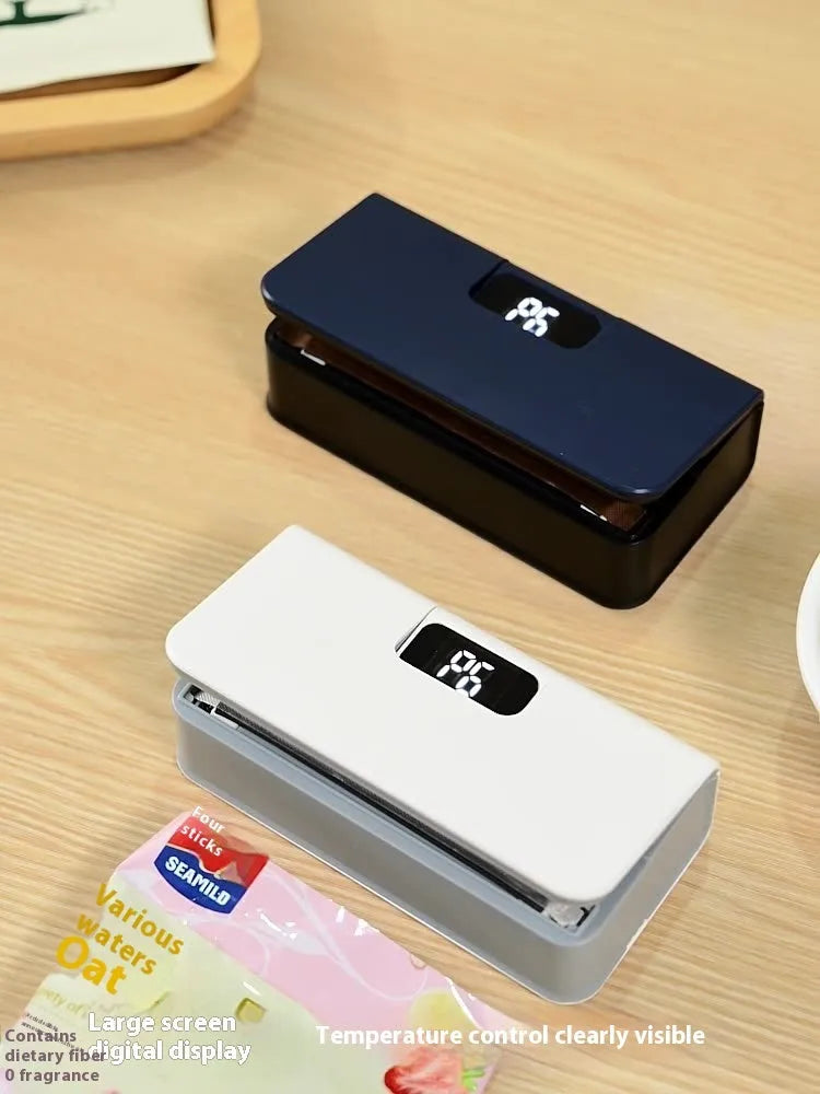 Small white and blue manual heat sealing machine for plastic food bags.