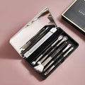 Makeup brush set in case with mirror showing 4 or 5 artificial fibre brushes in silver, gold or sparrow design