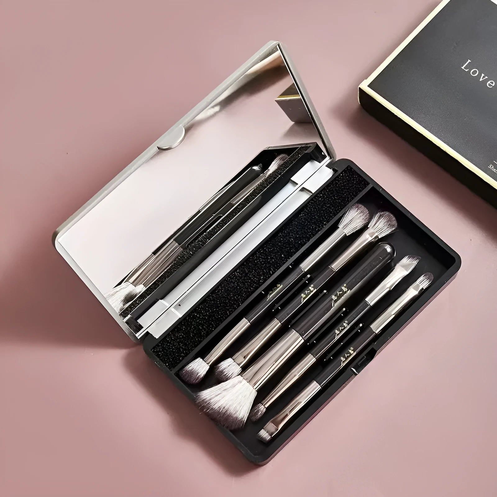 Makeup brush set in case with mirror showing 4 or 5 artificial fibre brushes in silver, gold or sparrow design