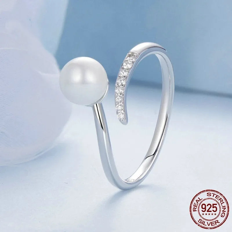 Open loop adjustable sterling silver ring with a white shell pearl.