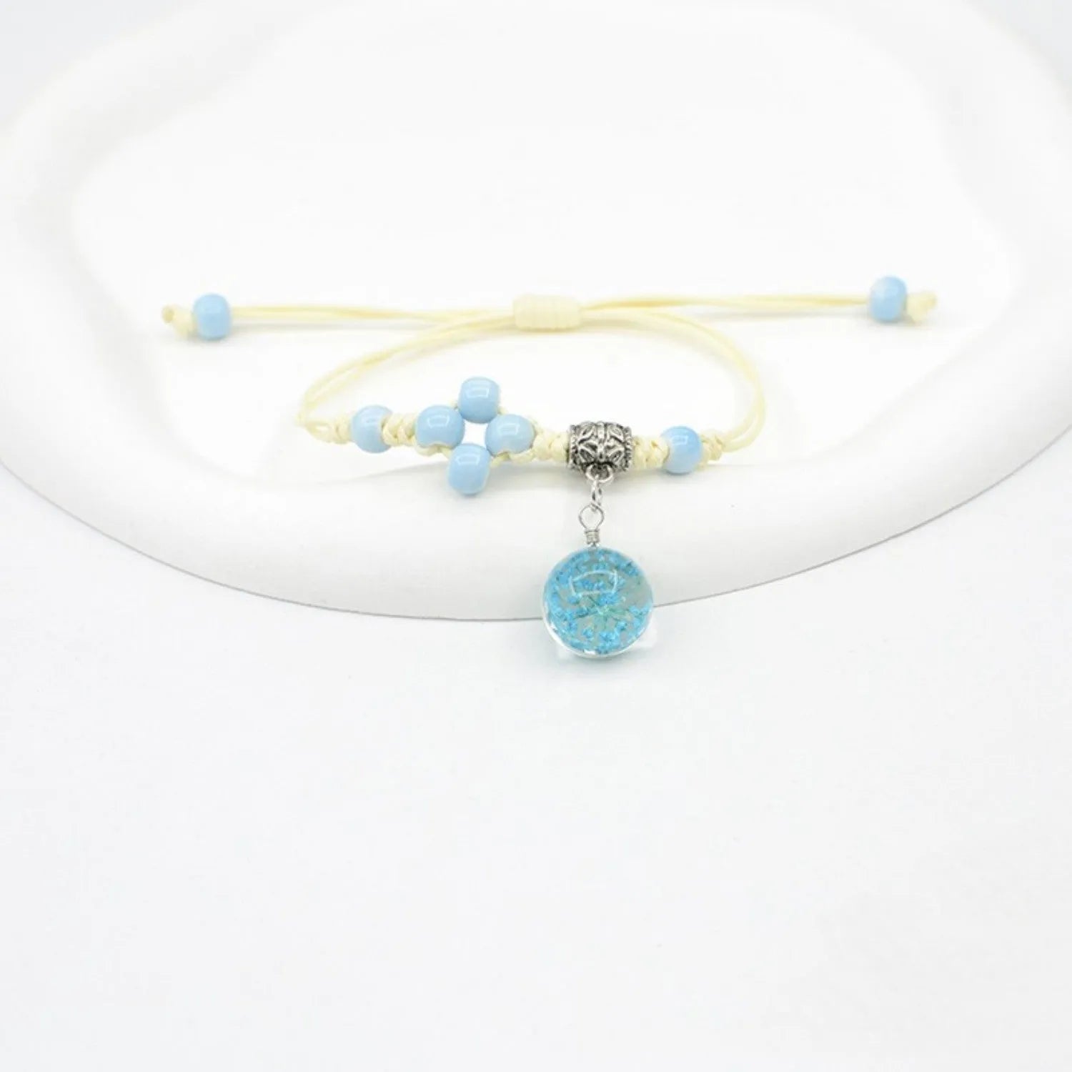 Hand-woven glass bracelet with 1.4cm beads containing real dried flowers in various colours