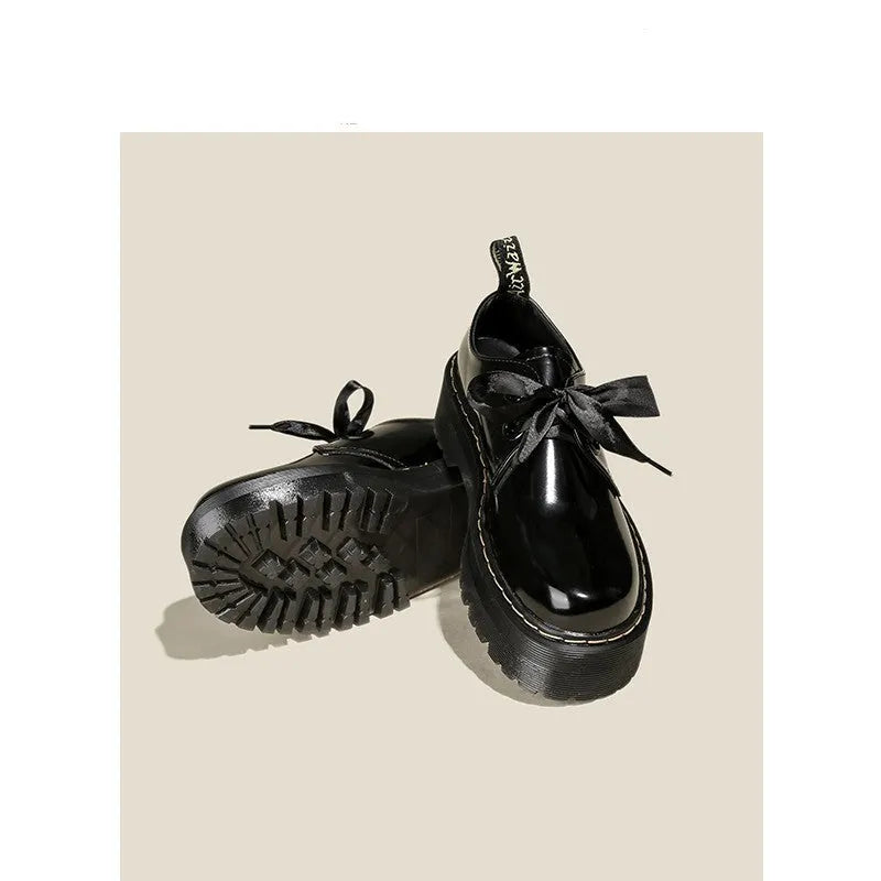 Women's black thick-soled leather shoes with cross straps and ribbon decoration