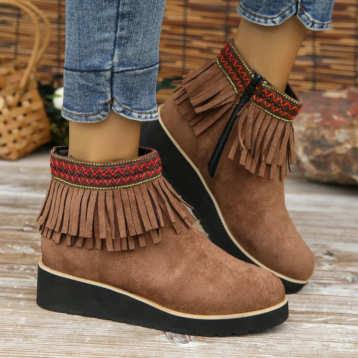 Women's dark brown suede wedge bootie with side zip, tassel detail, and thick rubber sole