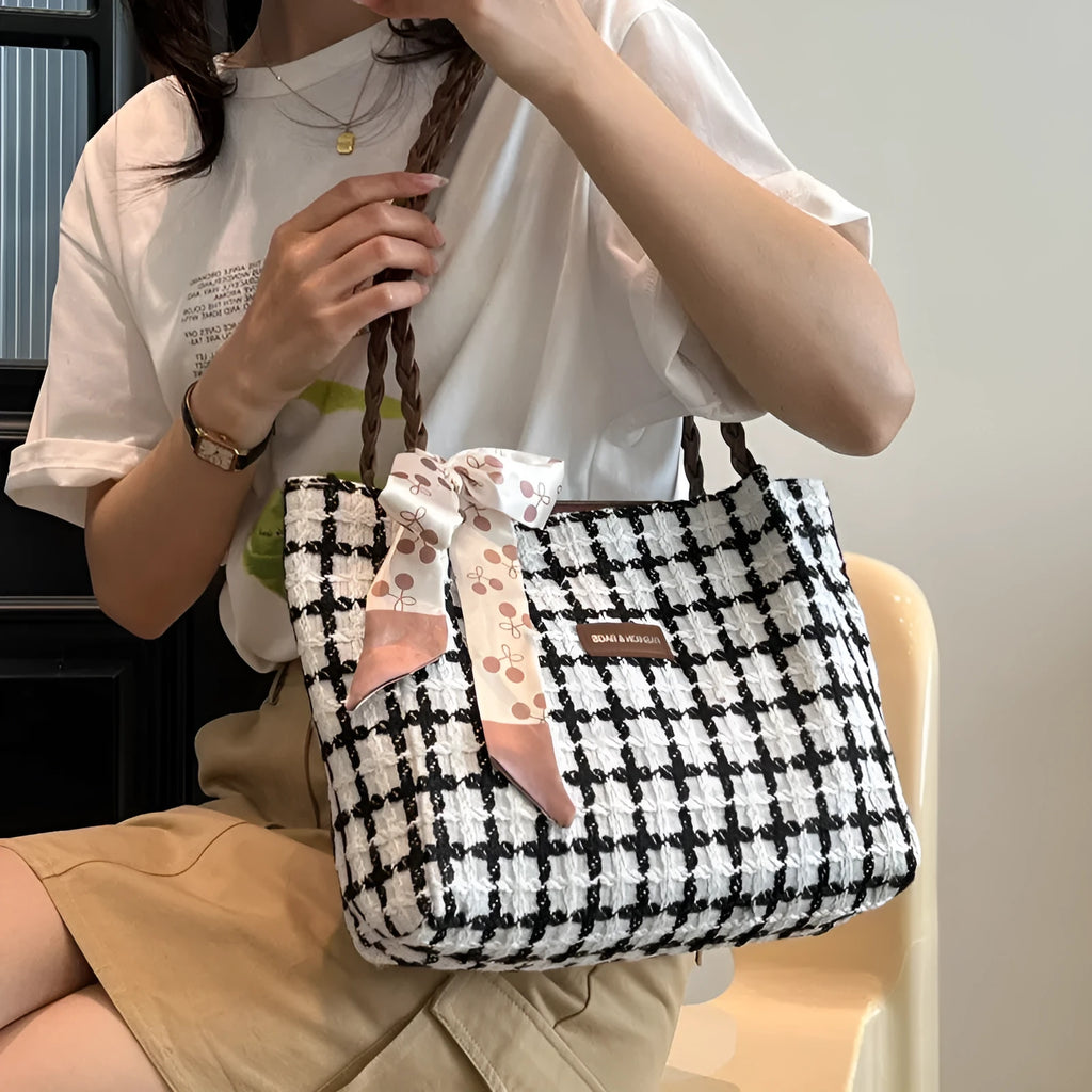 Black woven wool shoulder bag with horizontal square design showing internal organisation pockets and exterior sandwich compartment