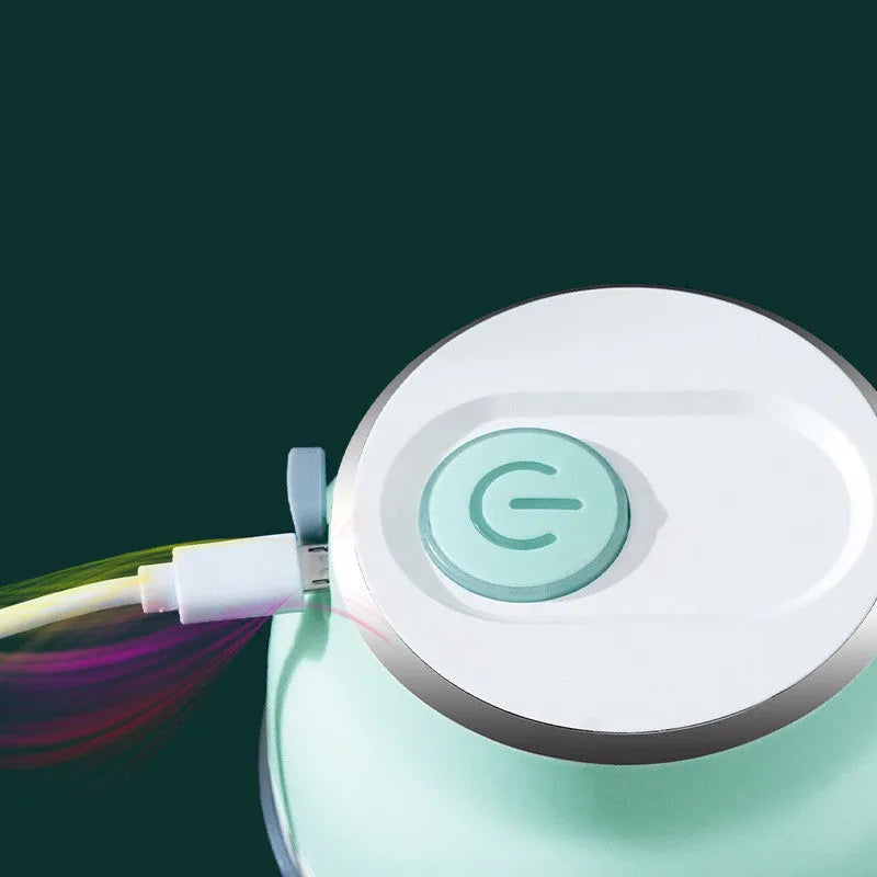 Green portable electric mini garlic cutter masher with transparent cup and USB cable, 150ml capacity on white background