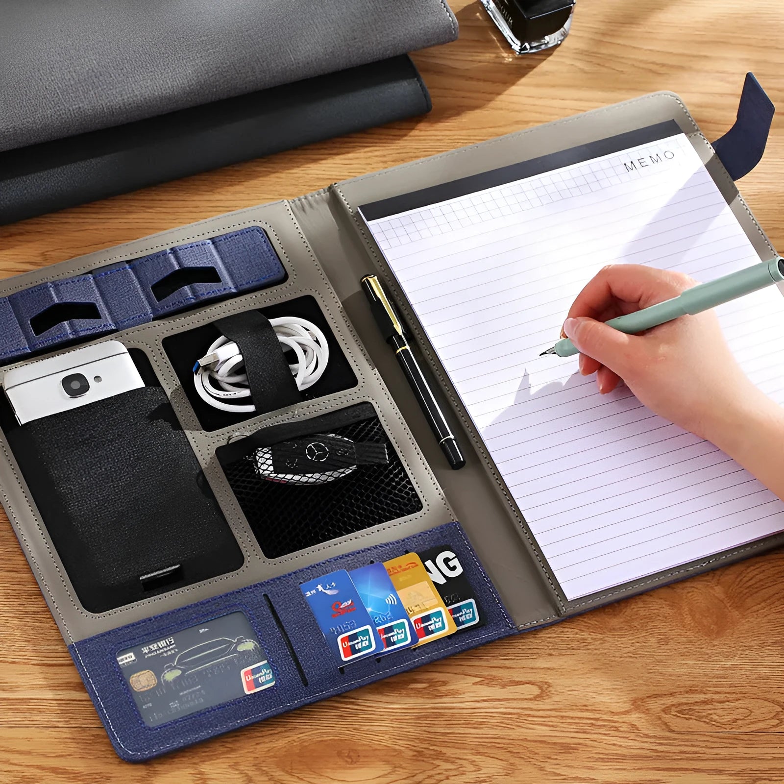 Leather A4 business folder in black showing document, pen, and notepad compartments