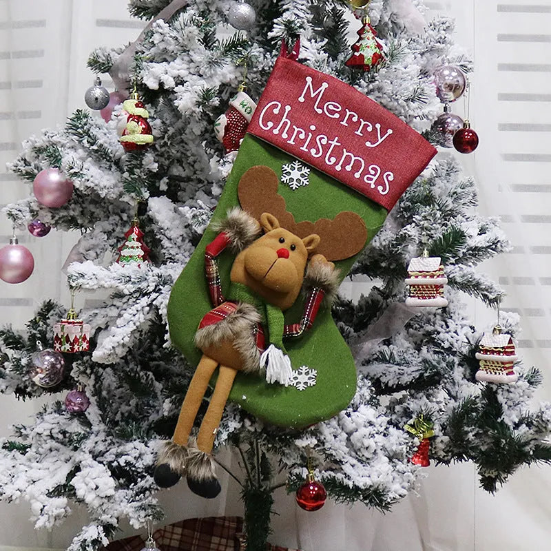 Set of three large 18-inch Christmas stockings with Santa, Snowman, and Reindeer 3D applique designs, hanging on a wooden mantel with festive decorations.