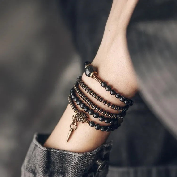 Black multi-layered beaded bracelet with geometric shapes showing natural style design