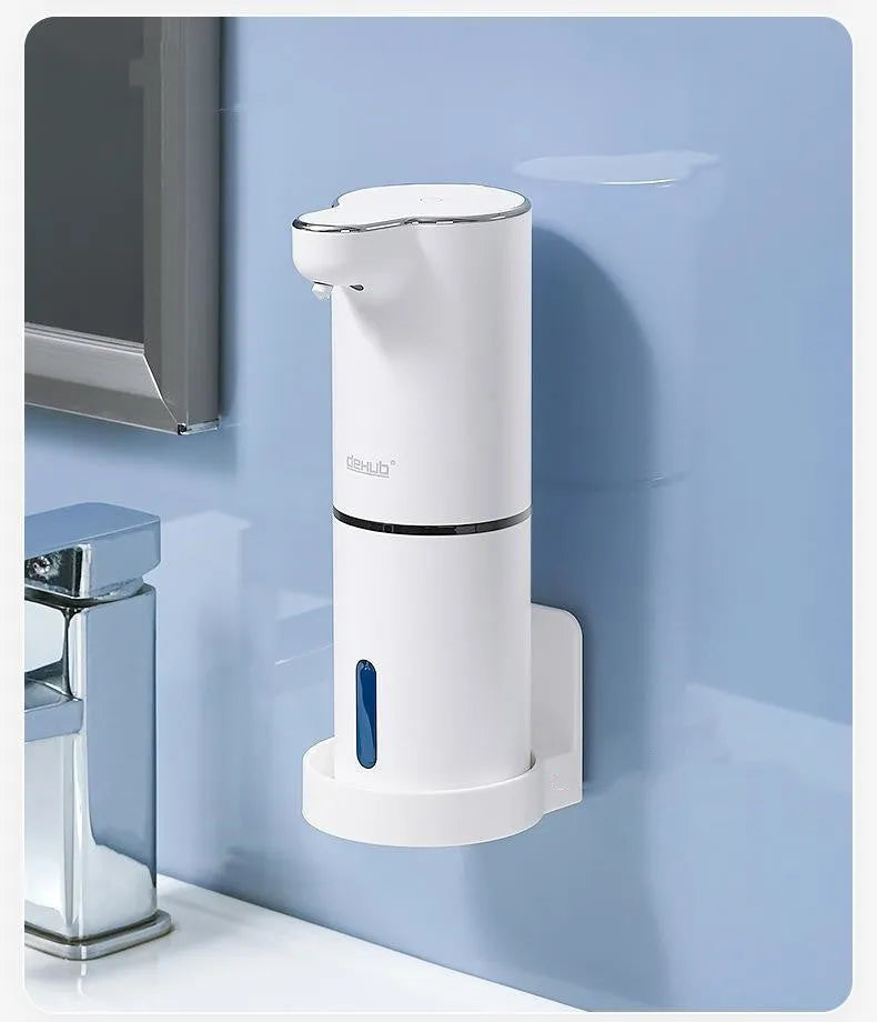 White ABS automatic sensor soap dispenser on countertop with USB cable, dispensing foam hand sanitiser.