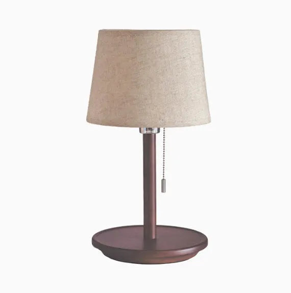 Walnut-coloured solid wood bedside lamp with fabric shade and cable switch