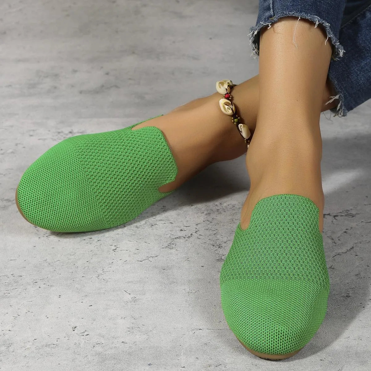 Apricot coloured mesh slip-on sandals with a round toe and flat rubber sole.