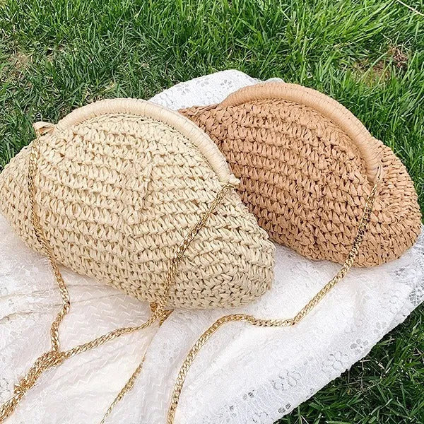 Women's khaki paper straw shoulder bag with chain strap and shell shape showing internal zippered compartment