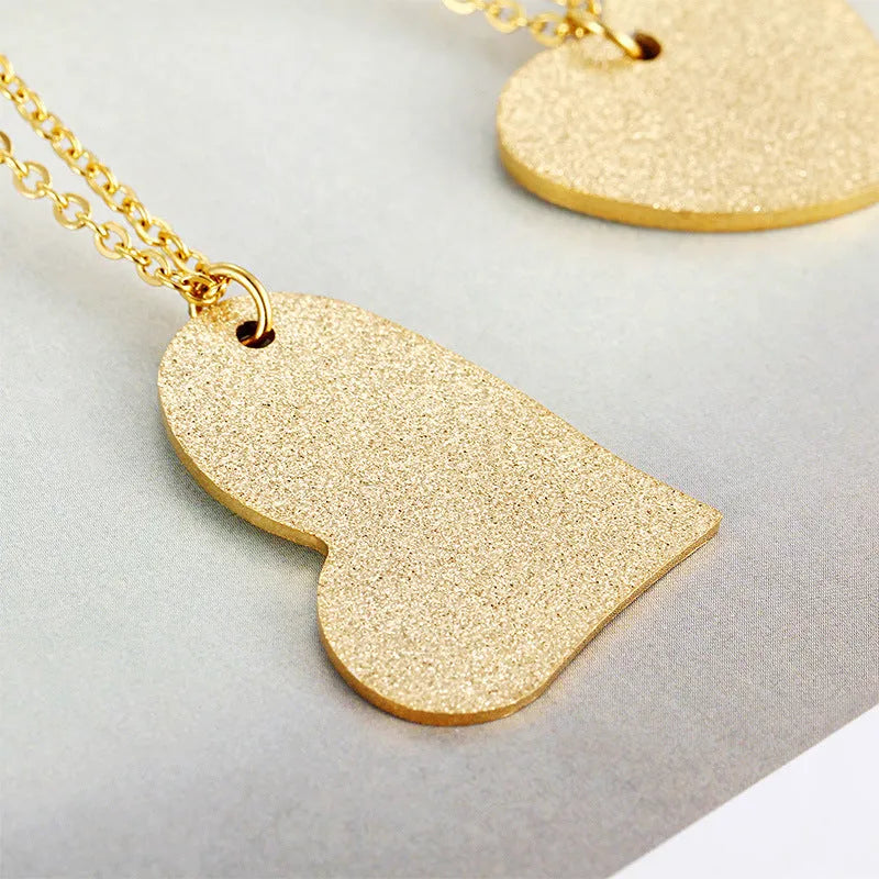 Geometric heart-shaped titanium steel pendant necklace on a model, colour KN25736-Z.