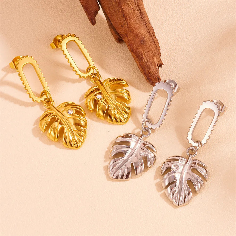 Heart shape titanium steel earrings in gold leaf style on white background