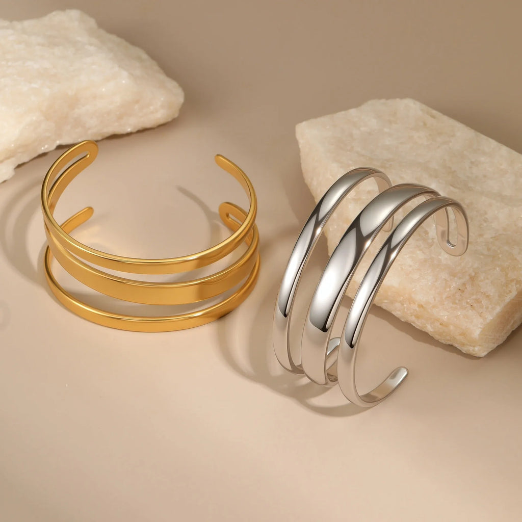 A geometric stainless steel bracelet with a simple opening clasp, shown in a gold electroplated finish.