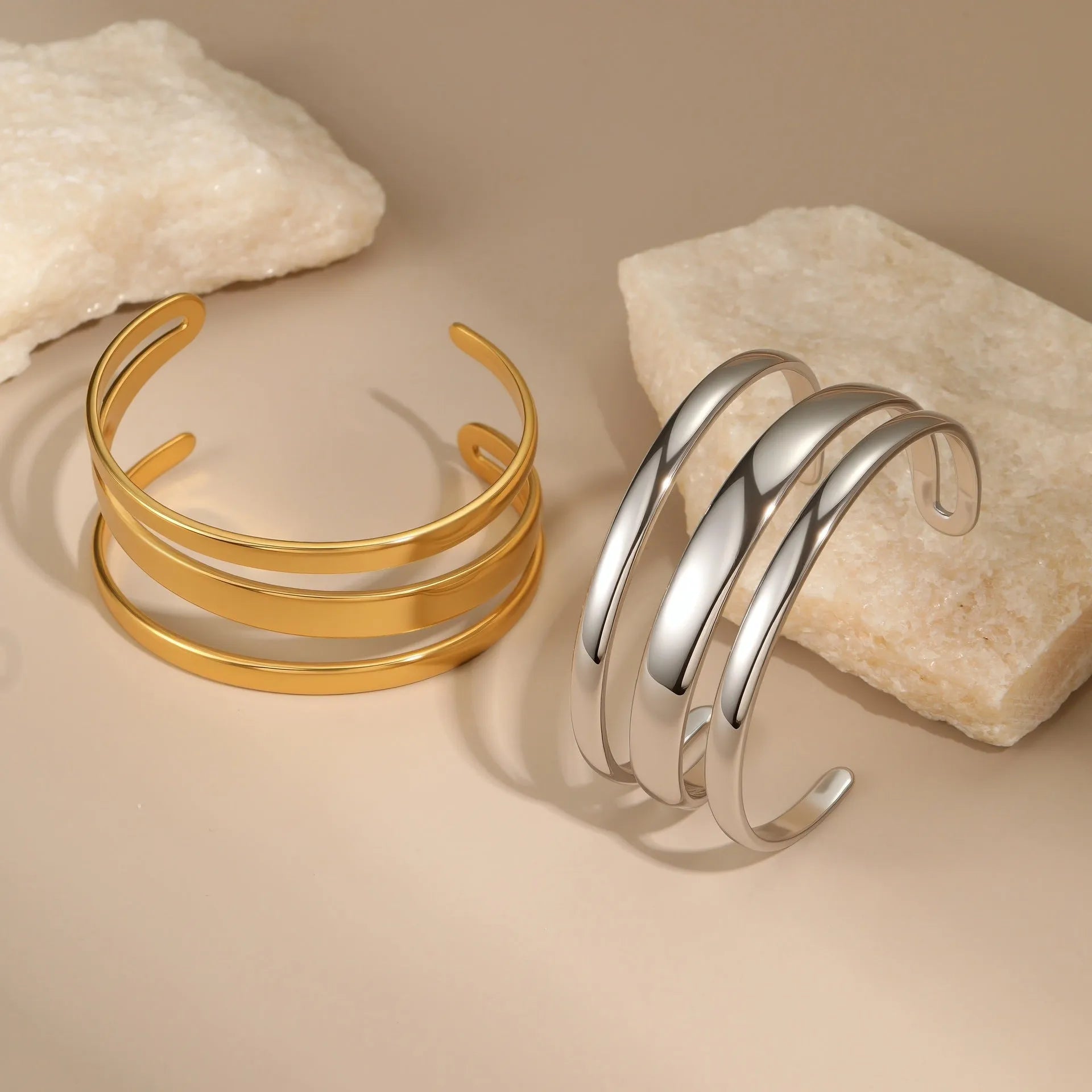 A geometric stainless steel bracelet with a simple opening clasp, shown in a gold electroplated finish.