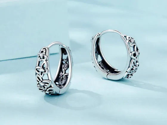 Retro hollow butterfly earrings in oxidised sterling silver with zircon stone accents on a white background.