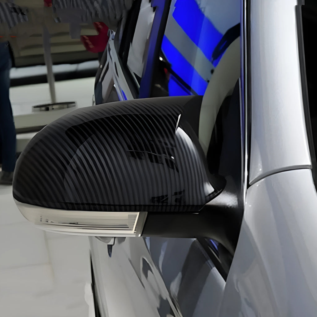 Pair of horn bright black plastic mirror housings for Volkswagen Sagitar with carbon fibre accents.