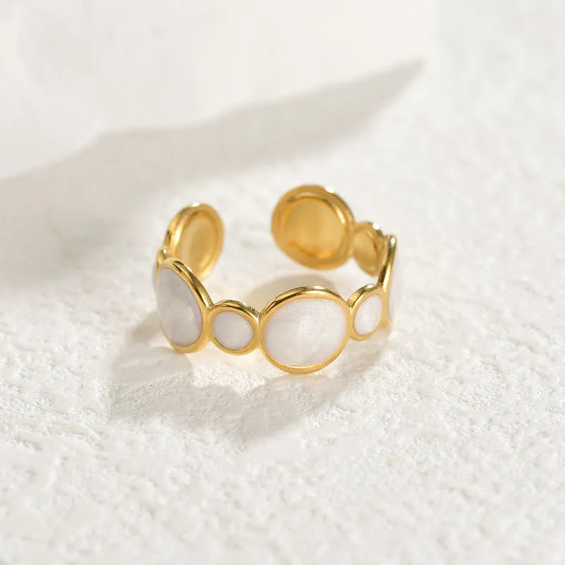 Adjustable geometric ring in stainless steel with electroplated finish, showing open design for flexible sizing