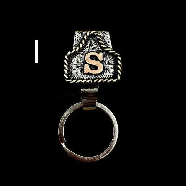 Handmade metal keychain with a cow tag charm in one of 26 available colour options.