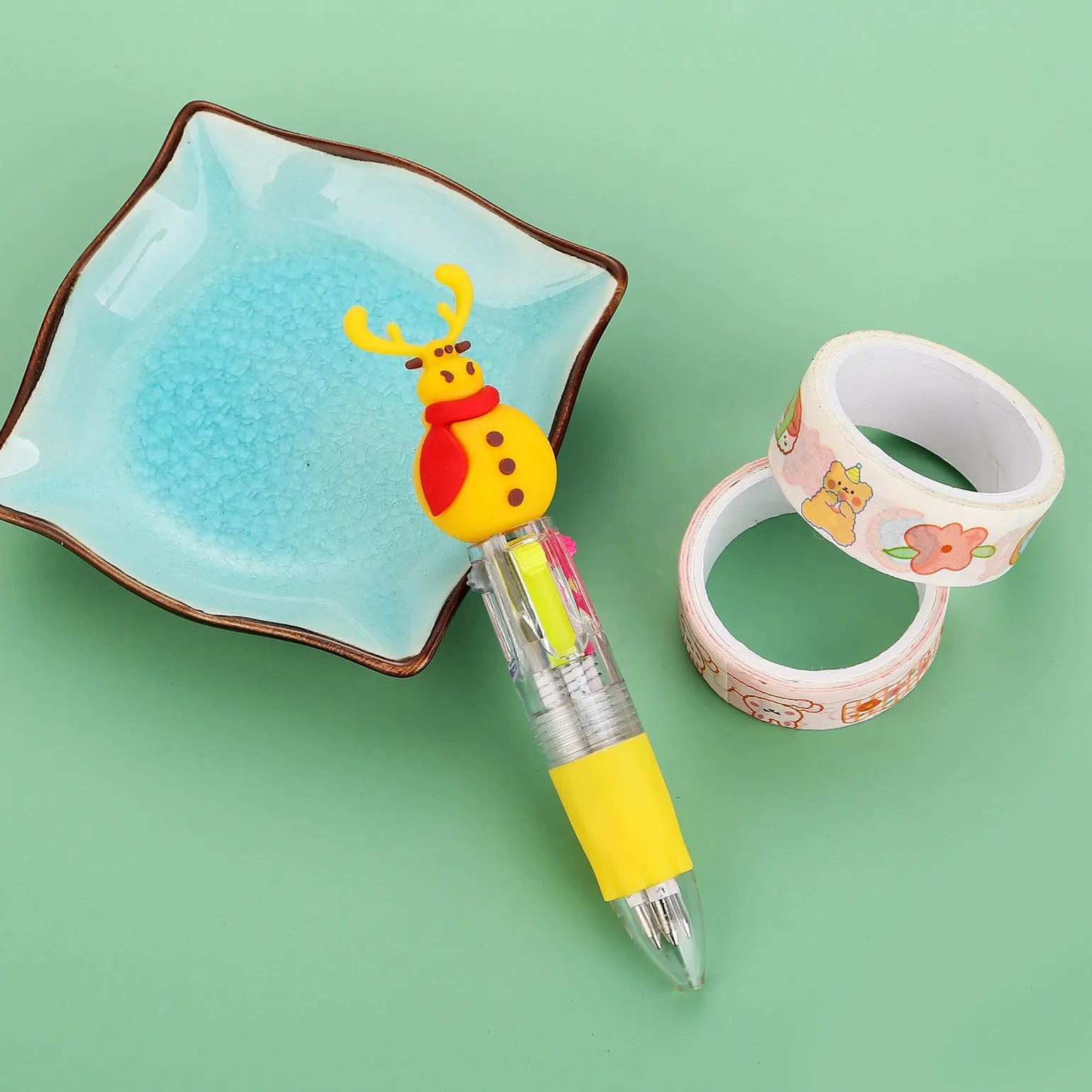 Compact 11cm Christmas-themed press-action ballpoint pen with festive designs.