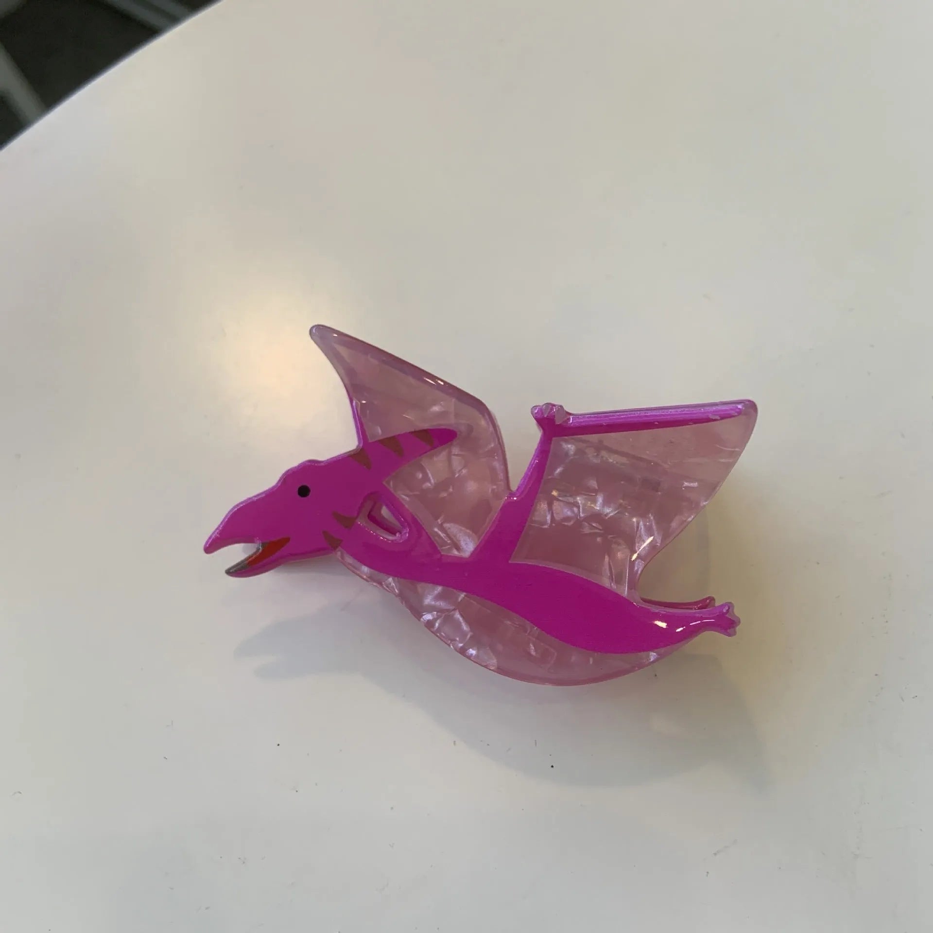 Dinosaur-themed acrylic jaw hair clip showing grip design with miniature dinosaur decoration