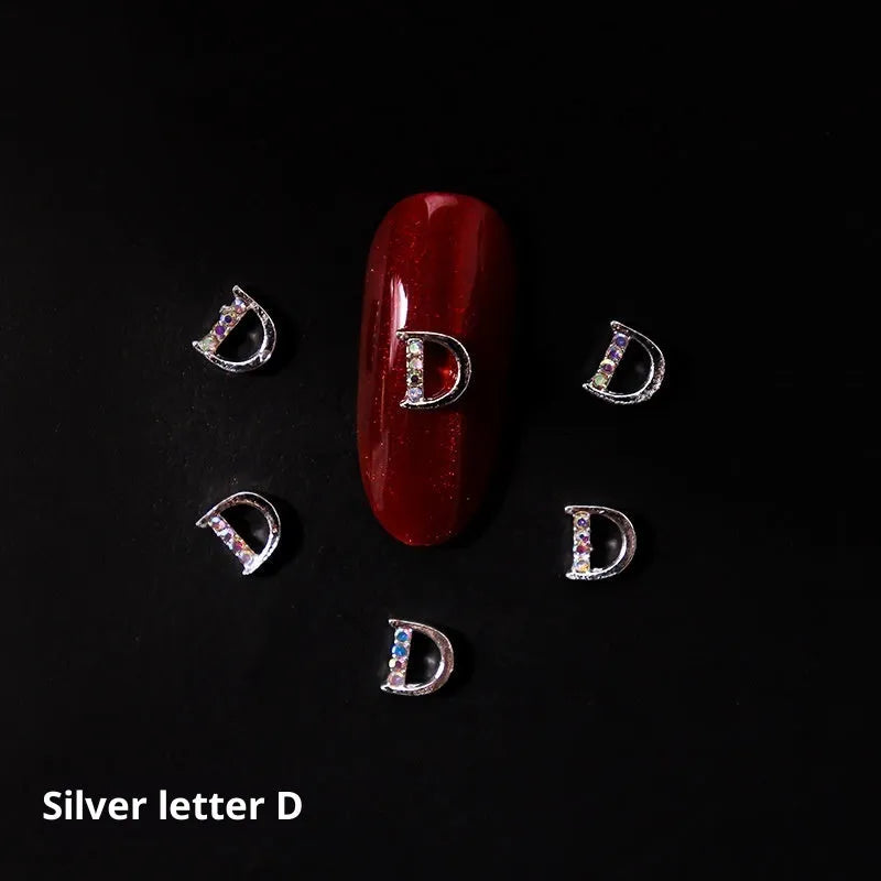 Gold alloy letter A nail ornament charm with crystal detail on a square chain base