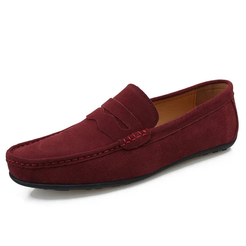 Men's solid colour suede loafers with round toe and rubber sole on a neutral background.