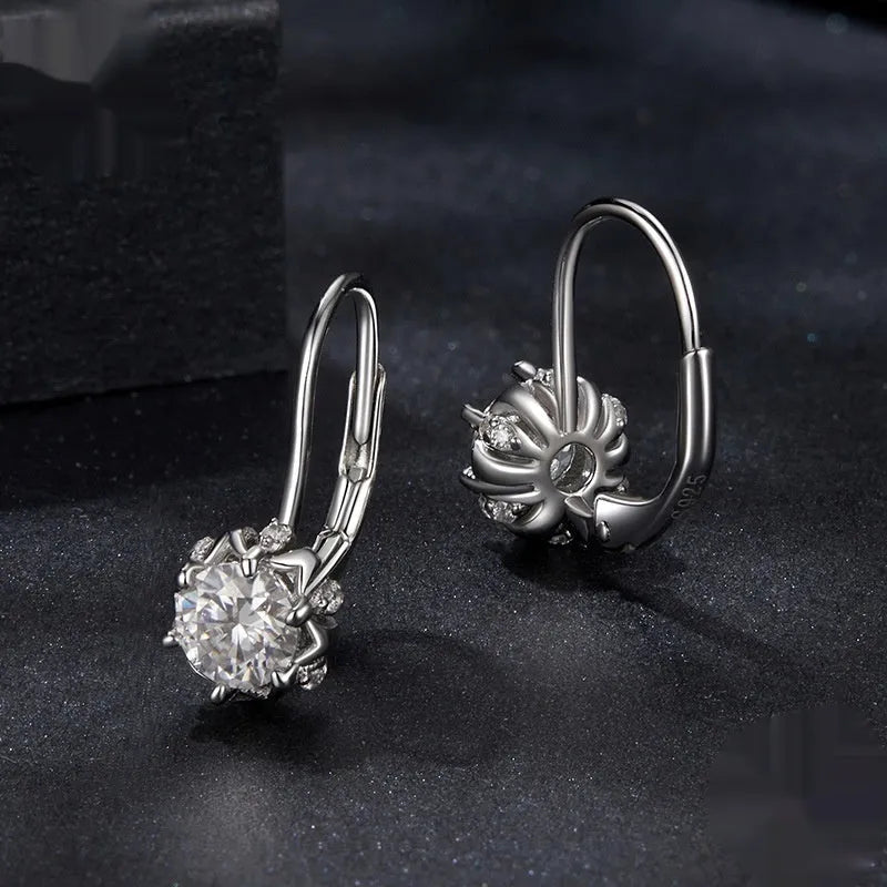 Sterling silver flower bud clip-on earrings with white gold plating and a central moissanite stone.