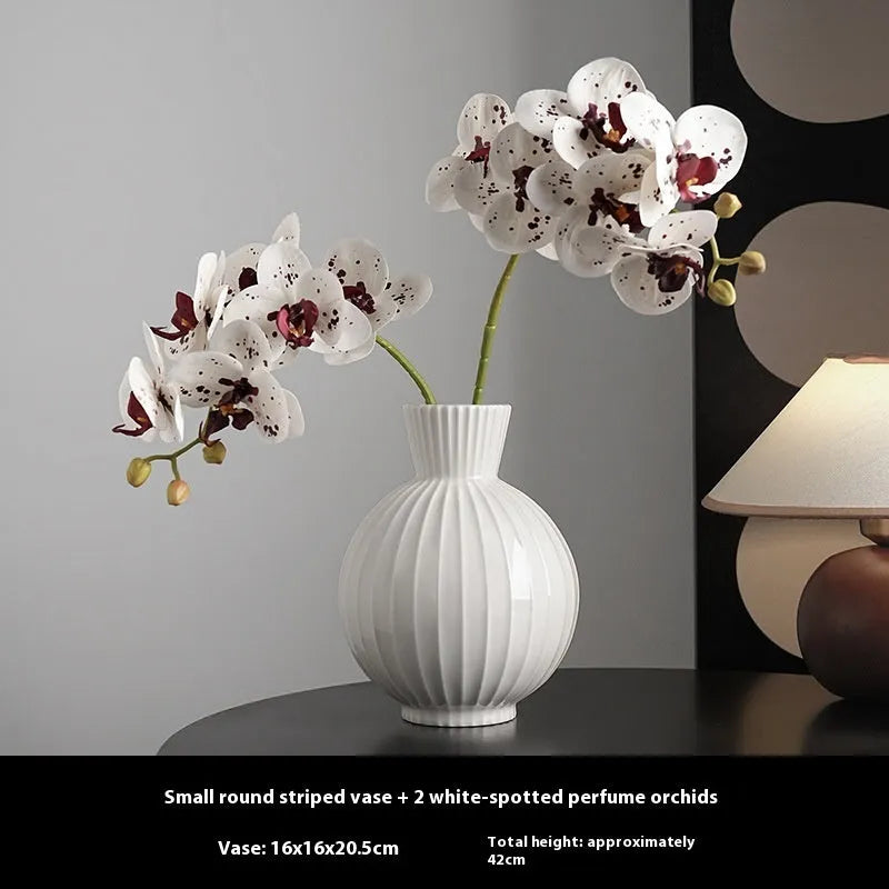 White ceramic ball vase with striped patterning in American country style on wooden table