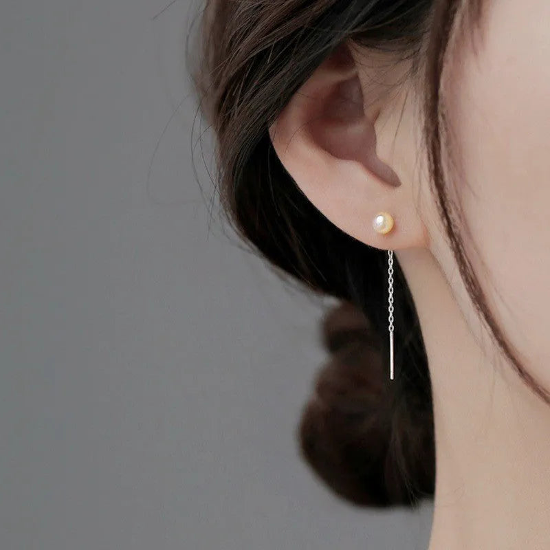 Long sterling silver needle ear string with a choice of geometric or pearl pendants for women.