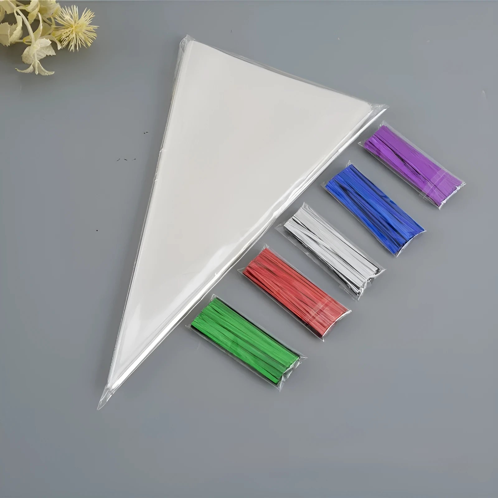 Transparent triangular plastic bag with a red wire tie closure.