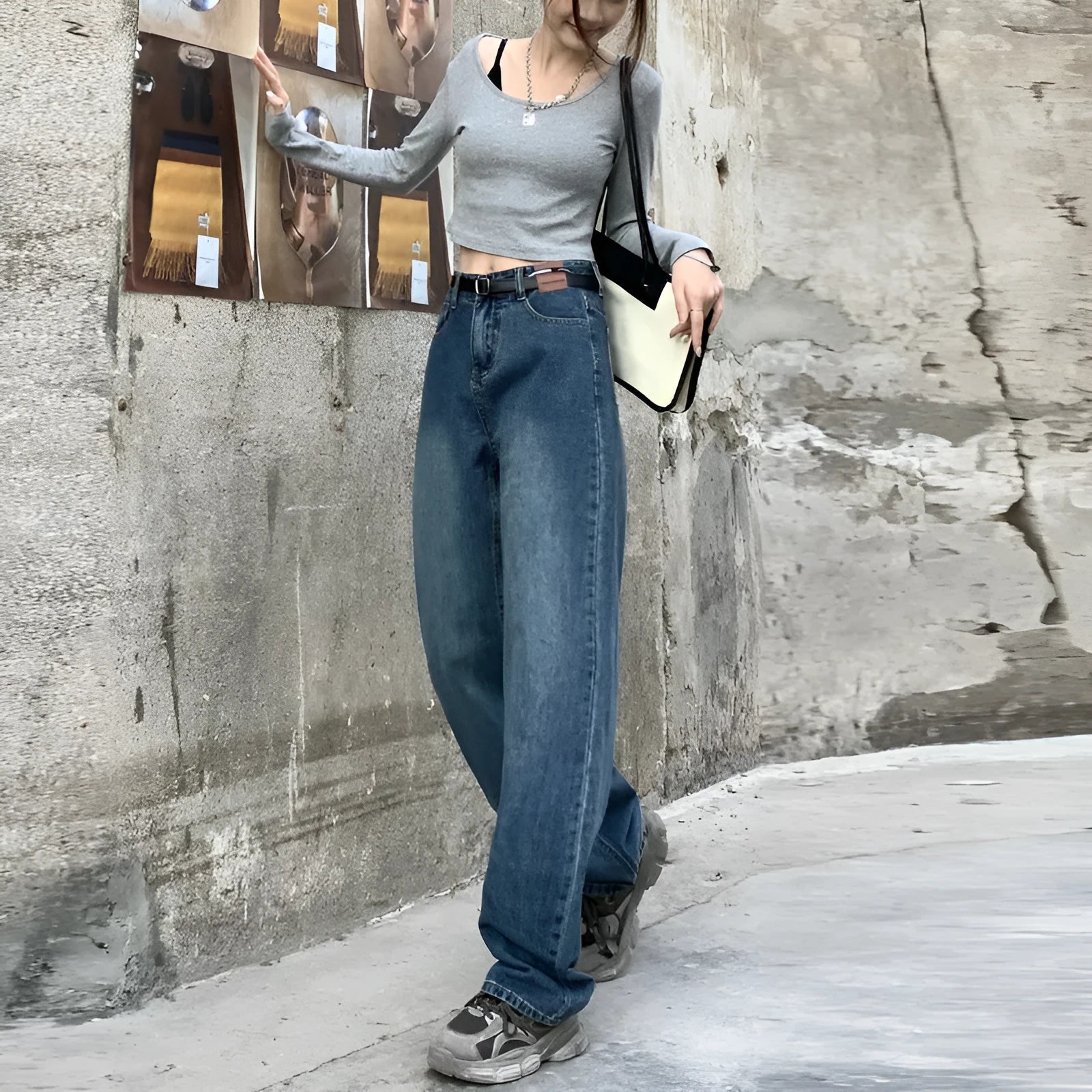A pair of women's retro blue high-waisted straight-leg jeans laid flat, showcasing the classic five-pocket design.