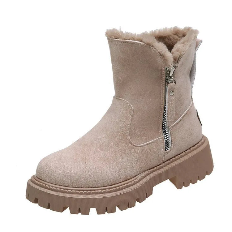 Women's black snow boots with foldable plush tube, suede upper, and rubber sole on winter pavement