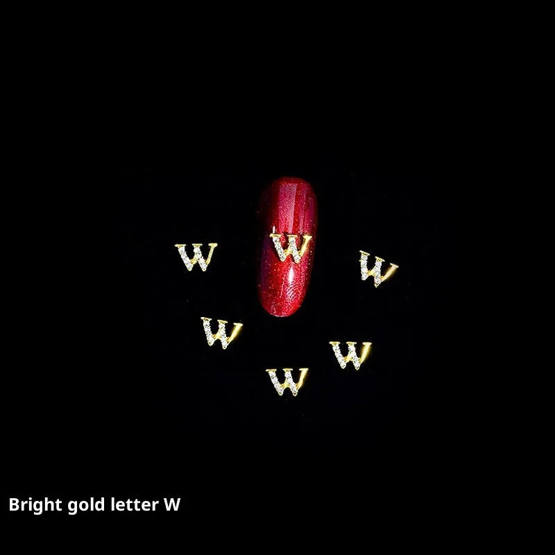 Gold alloy letter A nail ornament charm with crystal detail on a square chain base