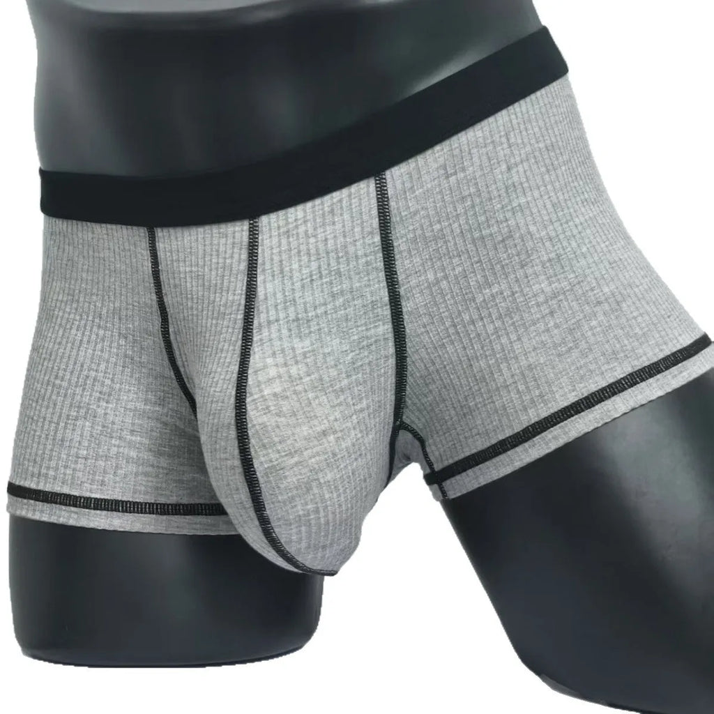 Solid colour men's boxers in breathable thin fabric offering hip lifting and body shaping support.