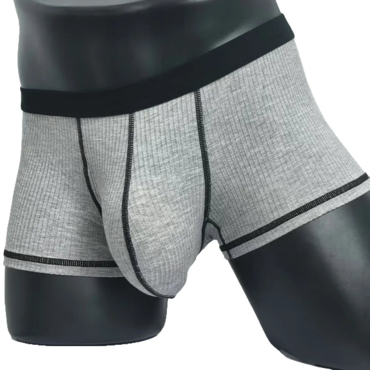 Solid colour men's boxers in breathable thin fabric offering hip lifting and body shaping support.
