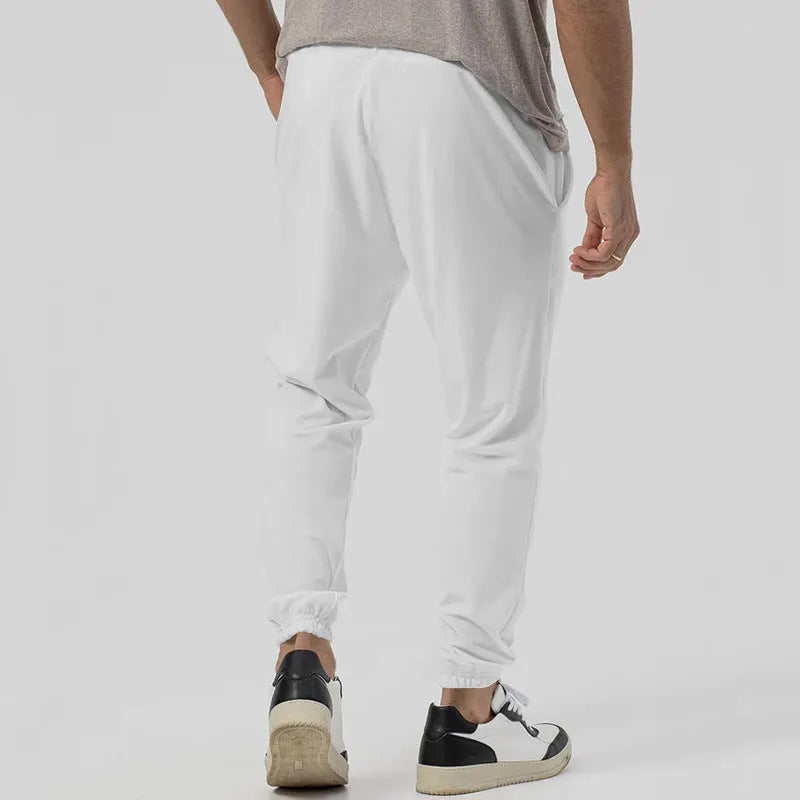 Men's loose tapered casual track sweatpants in cotton blend fabric showing straight-leg design