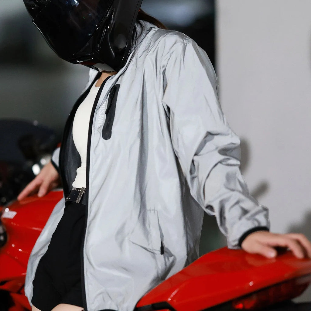 Silver waterproof polyester long sleeved outdoor coat showing windproof features across six European sizes