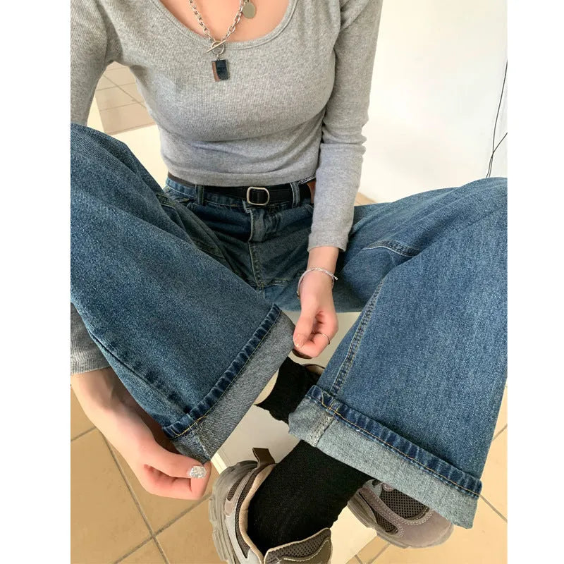 A pair of women's retro blue high-waisted straight-leg jeans laid flat, showcasing the classic five-pocket design.